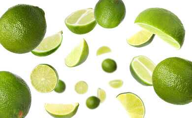 Fresh ripe limes flying on white background