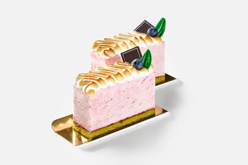 Delicious pink meringue cake garnished with fresh blueberries and chocolate
