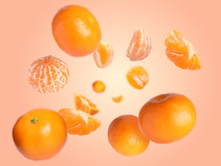 Juicy tangerines swirling in air against beige pink background