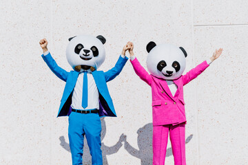 Storytelling image of a couple wearing giant panda head