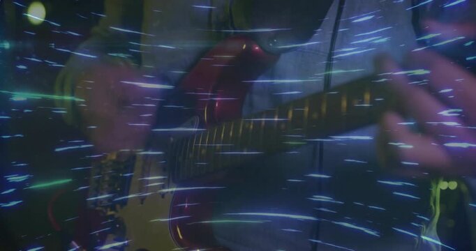 Musician pressing frets plucking chord on red guitar, activating swirling blue lights for music