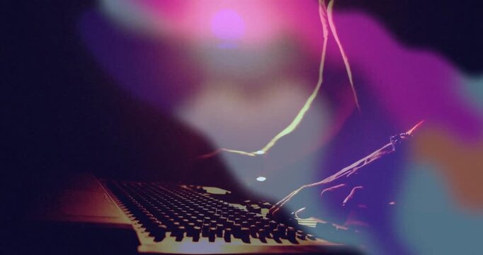 Audio engineer hovering hand above faders sliding mixer fader and twisting knob for refining mix