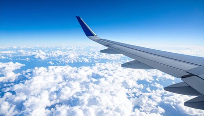 Obraz premium Airplane wing above clouds.View from airplane window a blue sky and clouds.