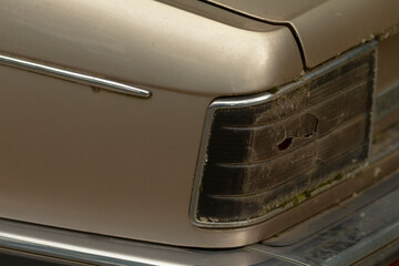 This is a detailed closeup image showcasing a cars tail light, which unfortunately has a hole in...