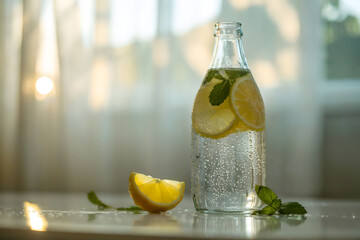Chilled Glass Bottle with Lemon Slices and Mint Leaves on Reflective Surface at Sunset with Soft White Curtains in Background
