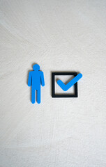 A human figure and a check mark in a checkbox. The concept of compliance with criteria. To mark...