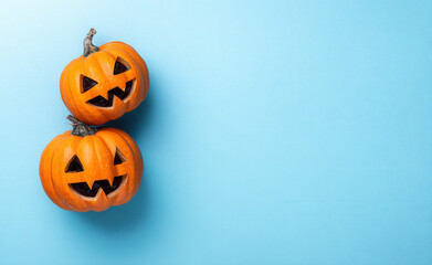 Halloween pumpkins on a blue background, a flat lay with copy space, top view, a minimal concept of the Halloween festival celebration and party concept