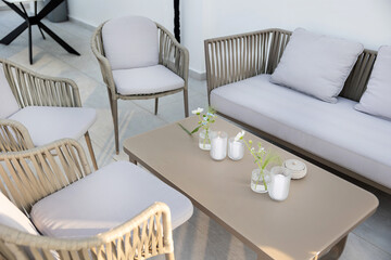 Modern Living Space Featuring Soft Gray Seating and Decorative Centerpiece with Candles and Flowers...