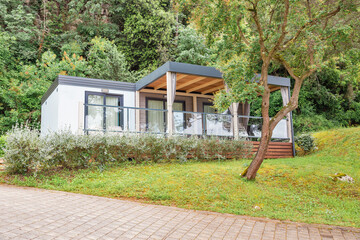 Premium mobile home with glass terrace in forest.