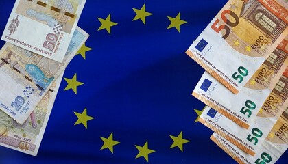 Bulgarian lev and euro banknotes displayed on EU flag. Concept of currency transition, financial...