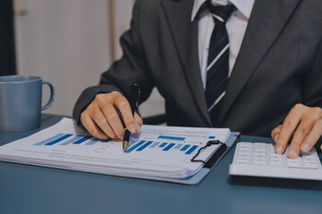 Business financing accounting banking concept. Business woman hand doing finances and calculate on...