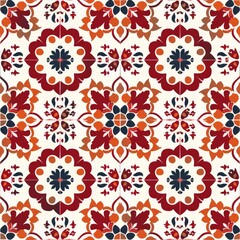A detailed seamless pattern showcasing stylized floral medallions in shades of red, orange, dark blue, and cream, arranged in a grid that evokes classic encaustic or cement tile designs.