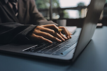 Close up of business woman hands typing on laptop computer and digital tablet, searching and...