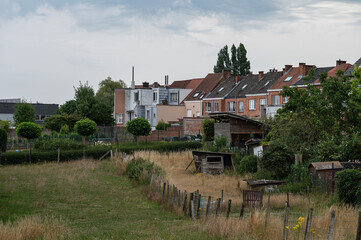 Colorful lawns and agriculture fields with residential houses in the village of Dilbeek, Flemish Brabant, Belgium