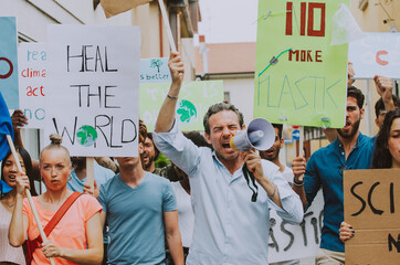 Public demonstration on the street against global warming and pollution. Group of multiethnic...