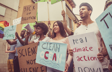 Public demonstration on the street against global warming and pollution. Group of multiethnic...