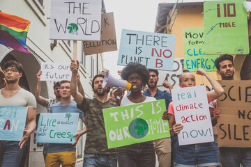 Public demonstration on the street against global warming and pollution. Group of multiethnic...