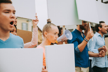 Public demonstration on the street against social problems and human rights. Group of multiethnic...