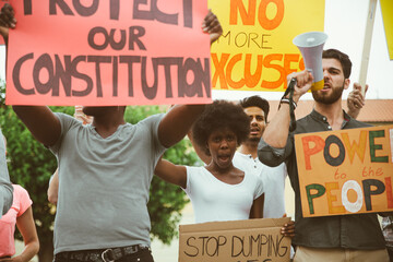 Public demonstration on the street against social problems and human rights. Group of multiethnic...