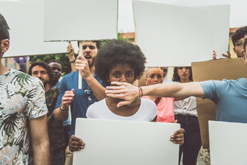 Public demonstration on the street against social problems and human rights. Group of multiethnic...