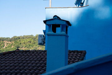 Charming blue chimney in Pueblo azul de Juzcar, Malaga, Spain showcasing unique architecture and...