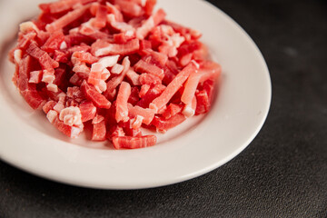 Bacon cubes smoked chopped meat small pieces fresh delicious gourmet food background on table rustic food top view copy space