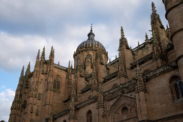 Majestic view of Catedral de Salamanca showcasing intricate architecture under a cloudy sky