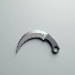 Curved karambit-style knife isolated on neutral gray background with soft lighting
