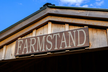 Rustic Farmstand Sign on Wooden Building
