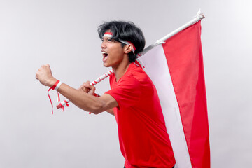 A young man passionately celebrates Indonesia’s Independence Day. His energetic pose and joyful expression convey national pride and excitement.