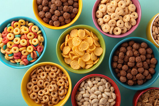 Assorted colorful breakfast cereals in bowls on bright surface offer a tasty morning meal - Powered by Adobe