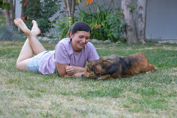 Woman relaxing in her garden with her dog