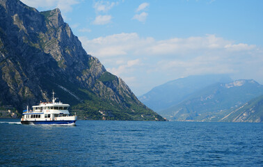 Lake Garda, smaller Ferry boat on the lake in the Background the Mountains of the west shore