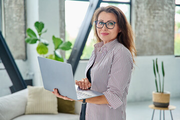 Middle aged business woman with laptop computer