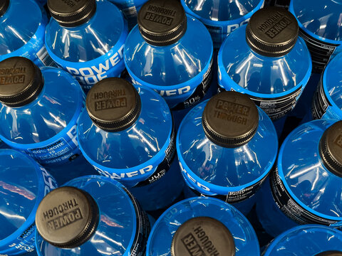 ATLANTA, GEORGIA - JULY 21 2025 : Powerade blue drink bottles on display at grocery store supermarket.