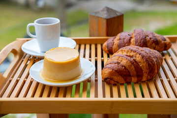 breakfast with creamy pudding panna cotta, fresh croissants, and coffee, Italian Morning, rustic...