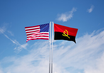 flags of angola and United States of America over blue sky background.