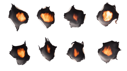 Collection of burnt holes in piece of paper on white background