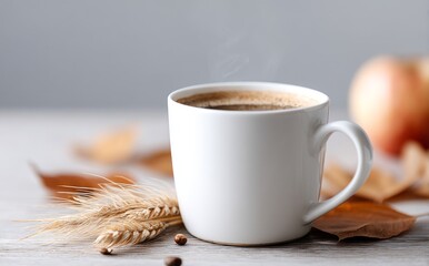 A cozy autumn setting features a cup of coffee, a selection of ripe apples, some stalks of wheat, and a display of colorful fall leaves on a wooden surface