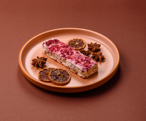 Nougat or white caramel with hazelnuts and strawberry pieces. White nougat