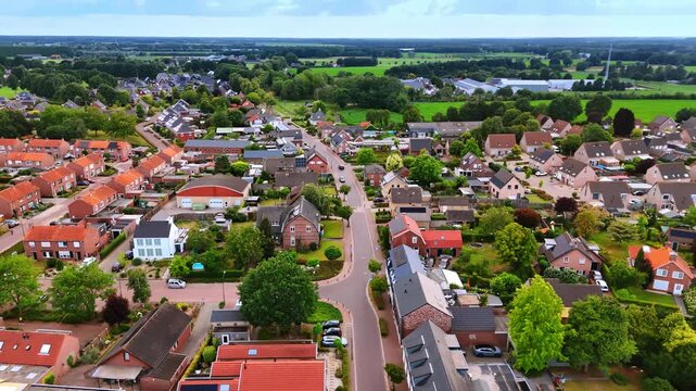 Cute houses in the cozy town surrounded by lush greenery. Aerial perspective on Vierlingsbeek, Netherlands.