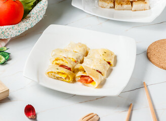 Savory Bacon and Egg Omelette Wraps with Delicious Breakfast or Snack in plate side view of hong kong breakfast food