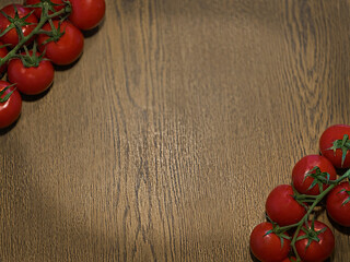 Red tomatoes arranged on a wooden table background. The scene features fresh, ripe tomatoes with...