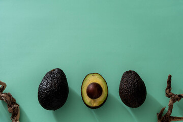
green background of three avocados with tree branches