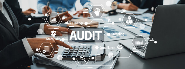 A professional team conducting an audit in a modern office environment, utilizing technology for...