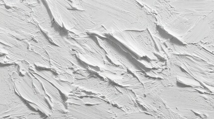 Obraz premium A textured white wall features intricate plaster patterns that create depth and visual interest. Natural daylight illuminates its artistic details, enhancing the overall aesthetic.
