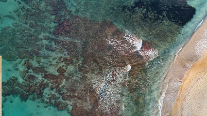 Minimal aerial view of coastal line with warm sand and blue water in Crete, Greece