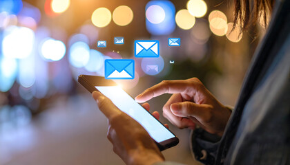 Woman checking emails on phone at night.
