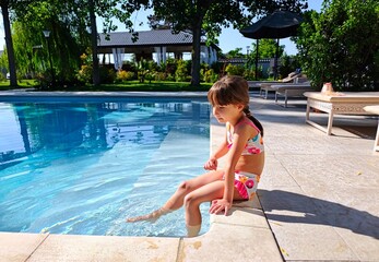 little girl and the swimming pool. High quality photo