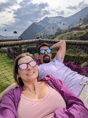 Relaxation and Joyful Connection in Tropical Nature – Hammock Lounge, Tranquility, Freedom, Bonding, Smiling Tourists in Rainforest Resort Outdoors